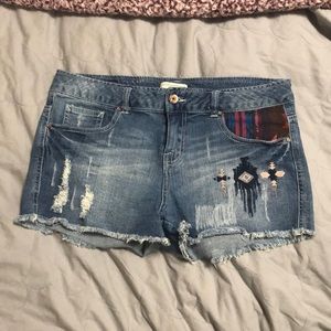 Size: large, low waisted denim shorts with a pop of color on the pocket